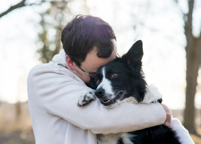 Male person hugging his dog