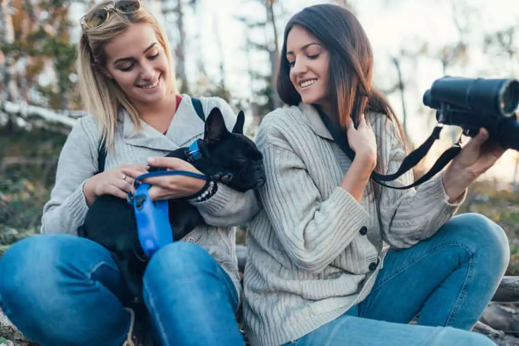 Women with a black french bulldog 