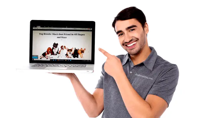 smiling man holding a laptop on his right hand