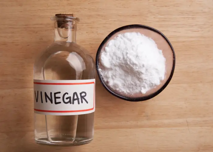 white vinegar and baking soda on a table